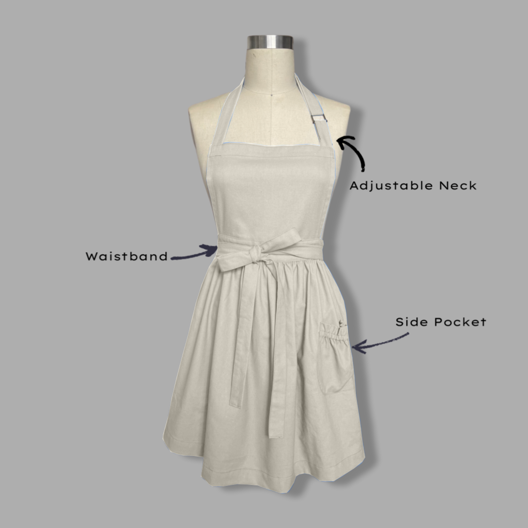 Beige apron on a mannequin with labeled features on a gray background