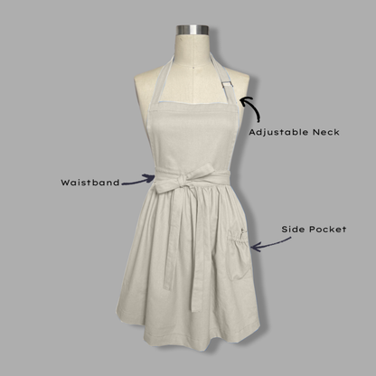 Beige apron on a mannequin with labeled features on a gray background