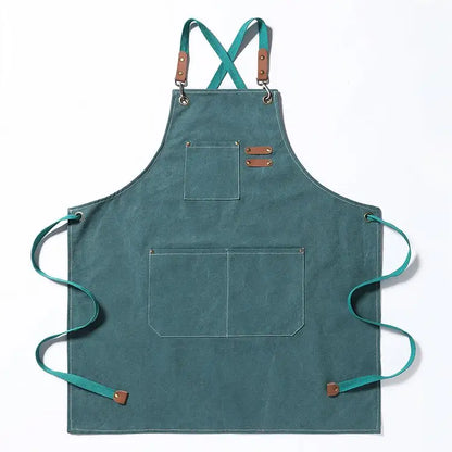 A purple apron with cross back straps, a top pocket, and two waist pockets with a pleather pen holder.